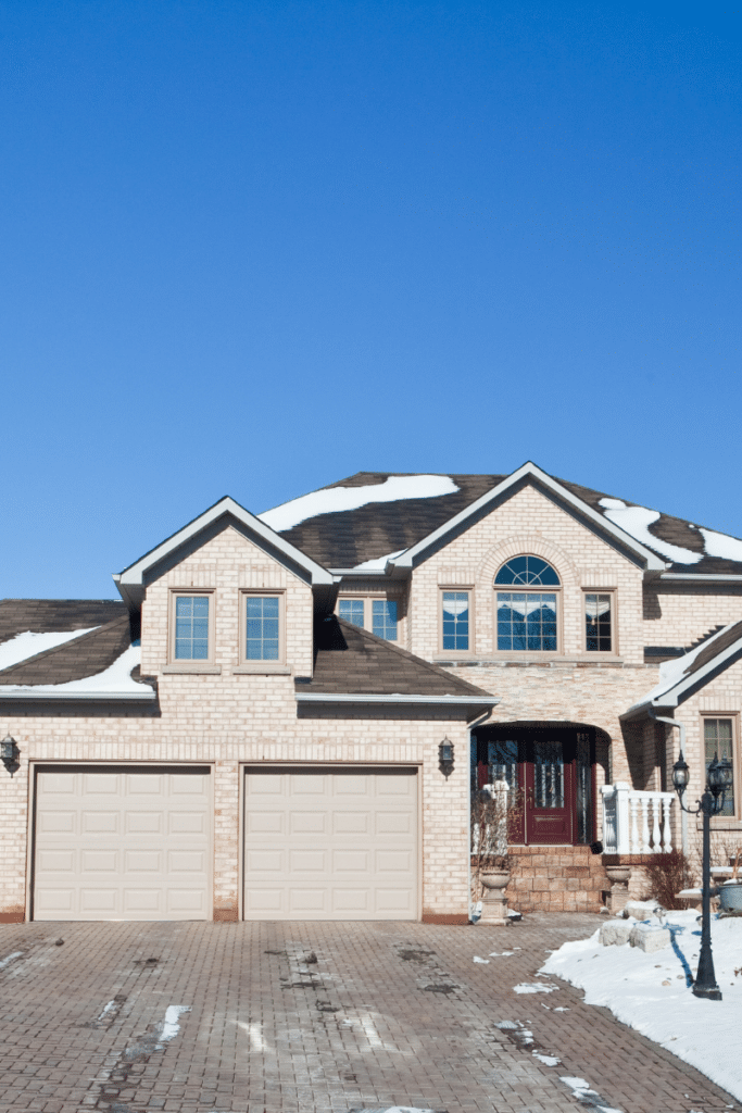 A cozy home covered in snow, showcasing the charm of selling your home in winter with a warm and inviting exterior.